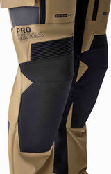 Schwarze RST Pro Series Adventure Motorradhose aus Sand- und Schwarzmaterial mit D3O-Schutz, strapazierfähig und bequem.