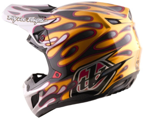 Motocrosshelm Troy Lee Designs Se5 Carbon Mips in Schwarz und Gold mit Overspray-Design, leichter, starker Schutz, sportlich.