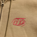 Troy Lee Designs Zip-up Badge Hoodie in Siena, bequeme Freizeitjacke mit Reißverschluss und Markenlogo, seitliche Taschen.