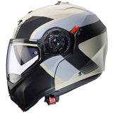 Matt-sand und schwarz-grauer Klapphelm Duke Evo Indy von Caberg, zeigt das Design und die stabile Klappfunktion des Helms.