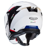 Caberg Jethelm Flyon II Boss in Weiß, Schwarz, Rot und Blau, mit Visier und aerodynamischem Design, auf einem schwarzen Hintergrund.